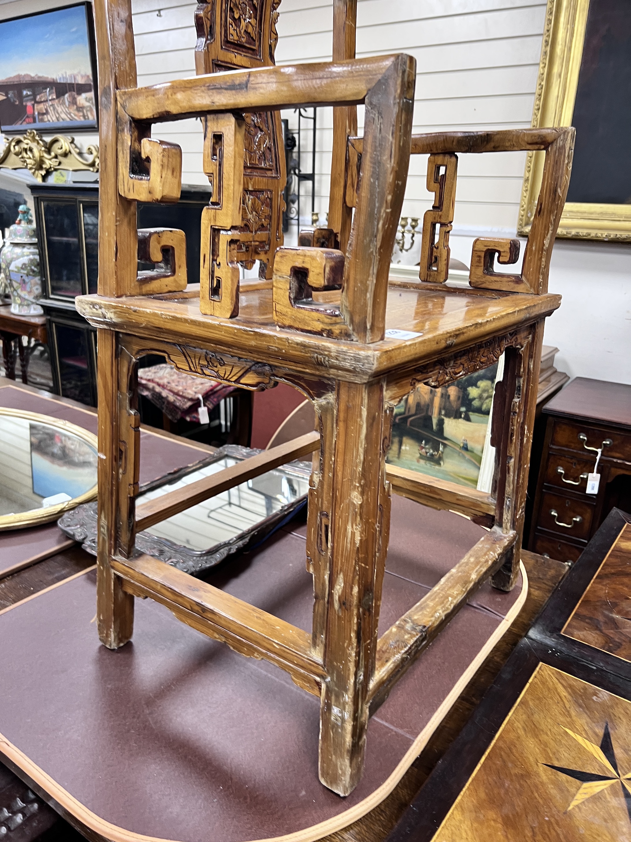 A Chinese carved pine armchair, width 57cm